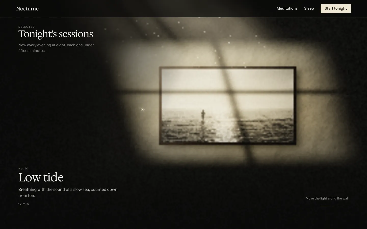 Window light falling across a dark wall of framed photographs, moving along it from one to the next.
