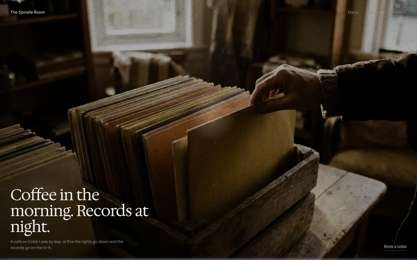 After: the same café in Small light in the dark, a hand leafing through a crate of records in low light, under Coffee in the morning. Records at night.